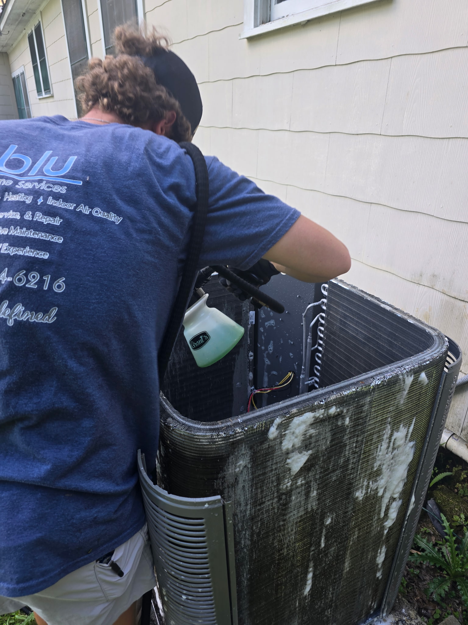 BLU technician servicing an AC unit