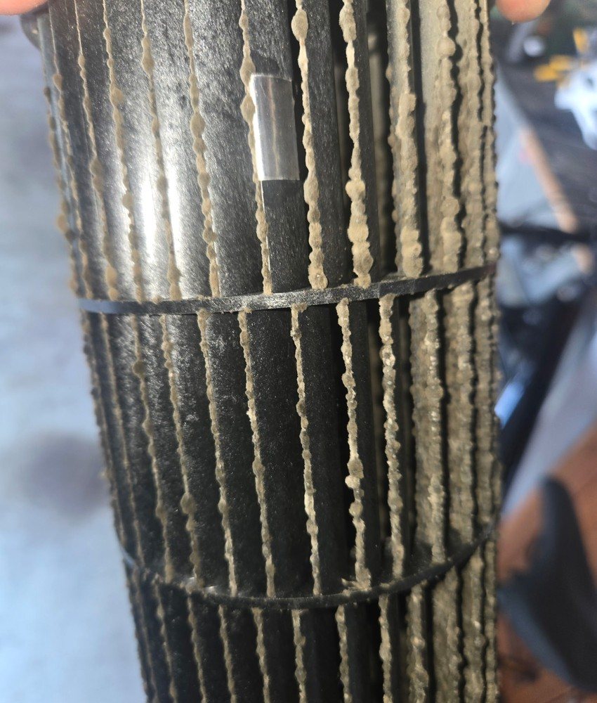 Dust and buildup visible on an HVAC blower wheel before preventative maintenance