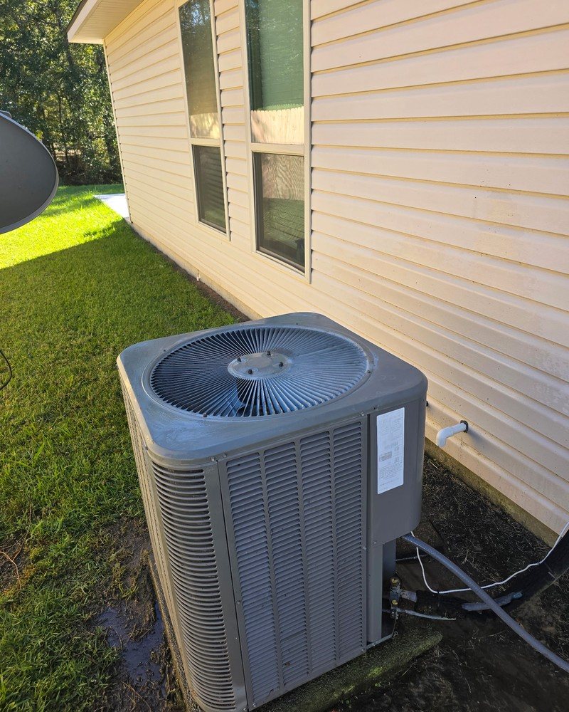 Residential outdoor air conditioning unit beside a Southeast Louisiana home